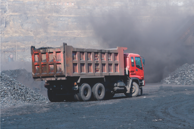An image of a red dump truck in a mining area.